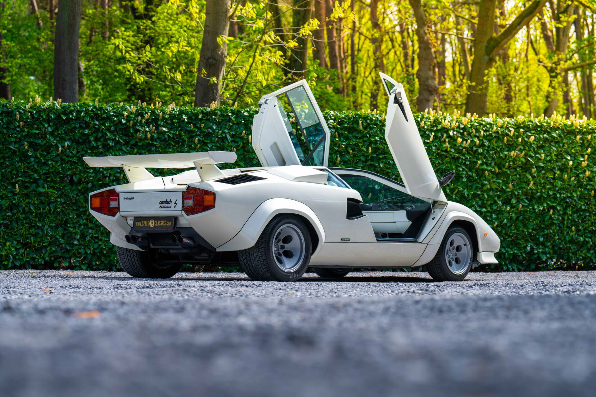White Lamborghini Countach with rear wing and open doors