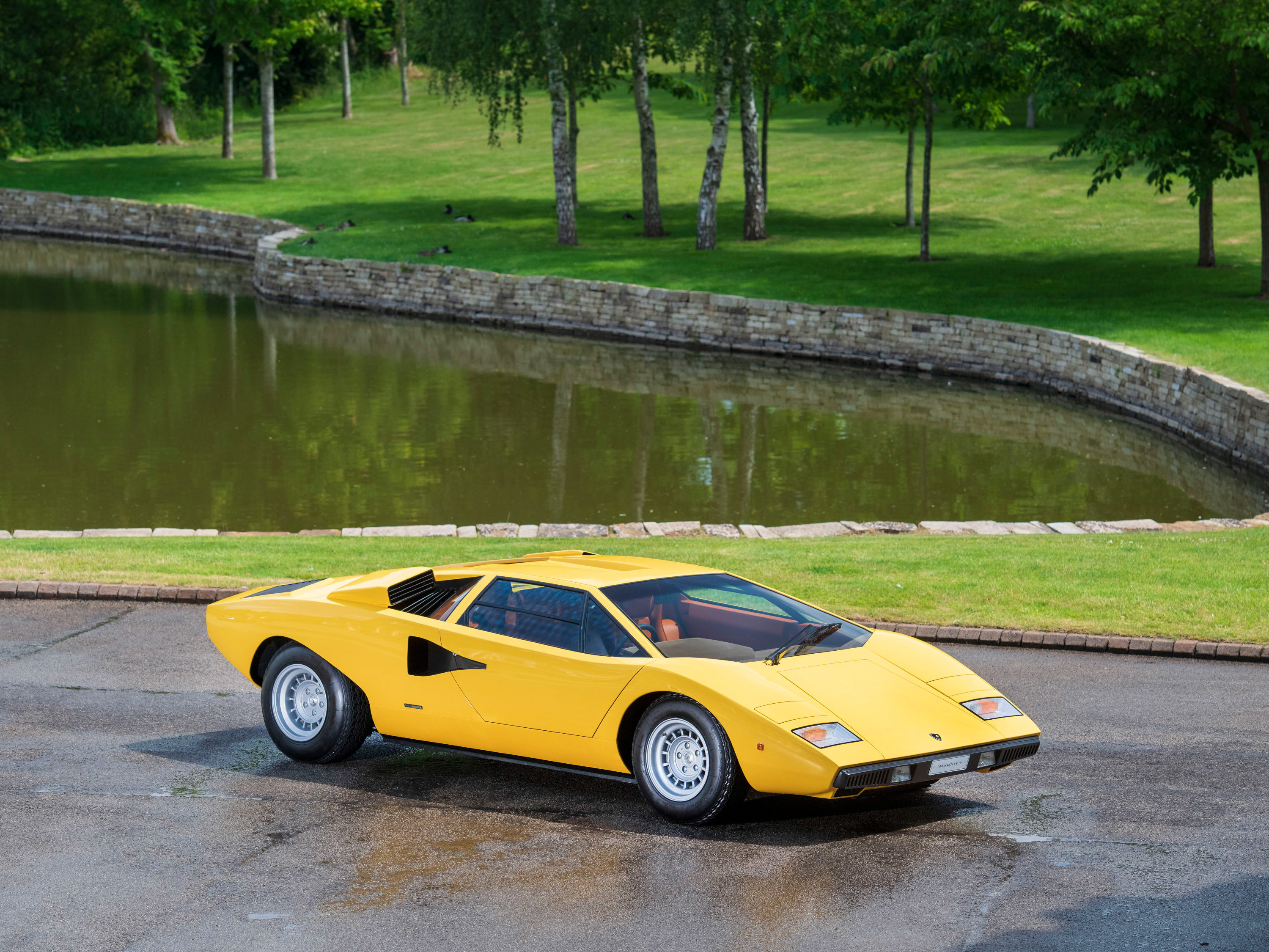 Yellow Lamborghini Countach LP400 by pond